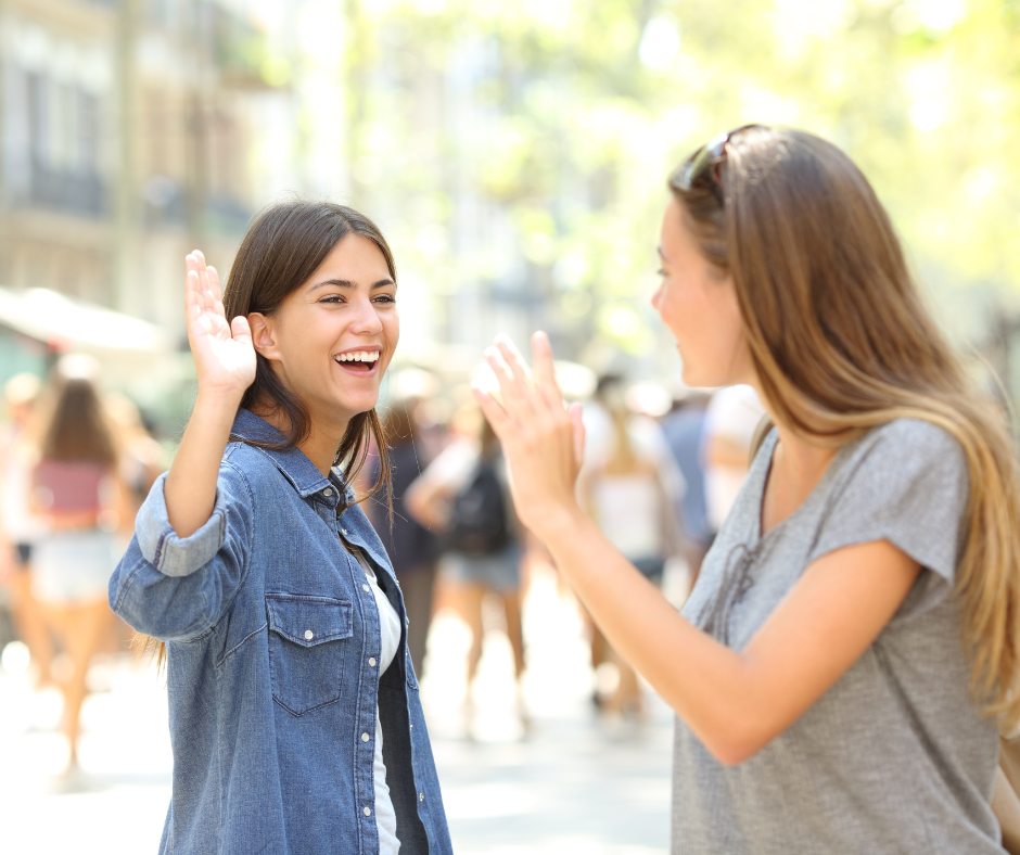 two girls greeting each others